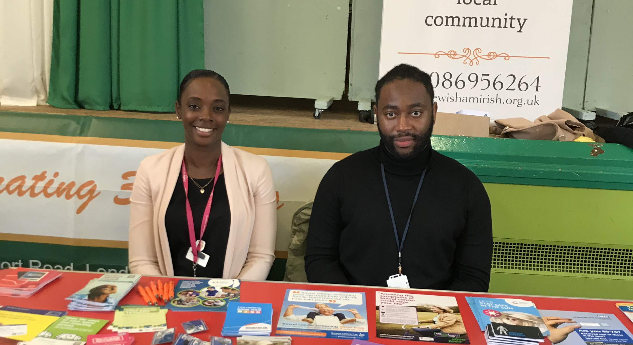 Niyah Drummonds and Chanise Campbell with materials raising awareness of bowel cancer.